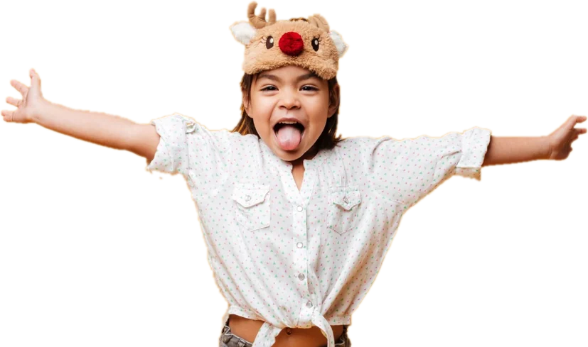 A girl with her arms flung wide, laughing