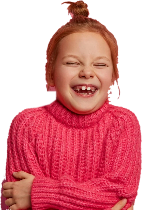A girl laughing with her eyes shut, hugging herself